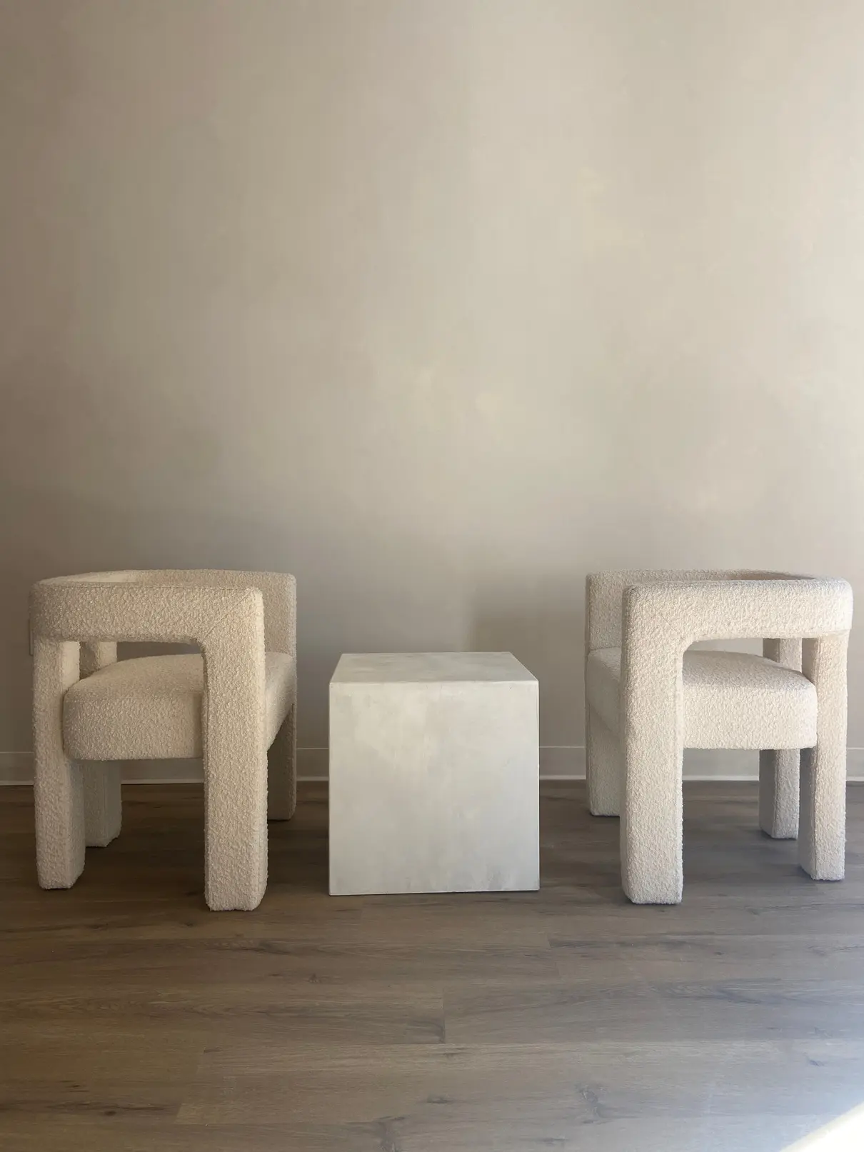 Limewash wall behind a sculptural seating arrangement